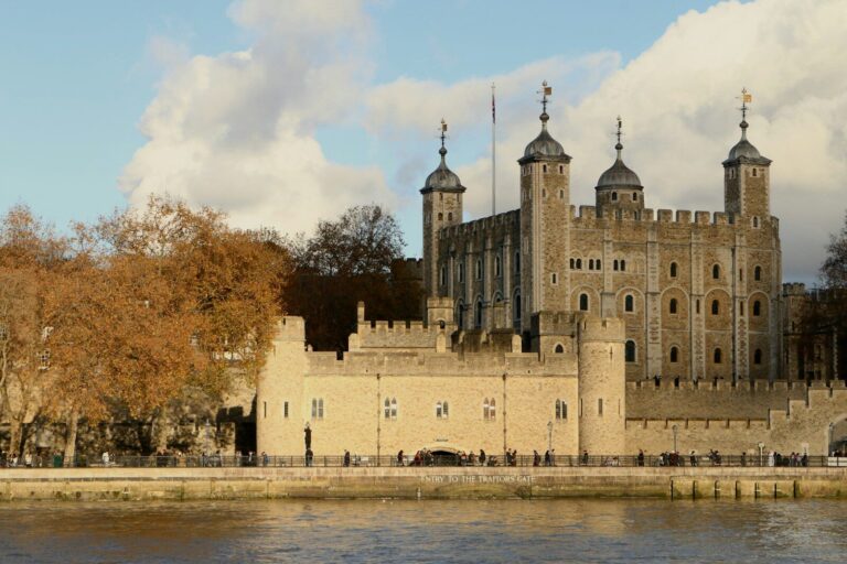 a large castle with towers on the side of a body of water