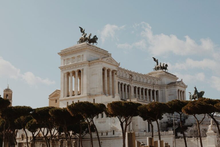 people walking on street near white concrete building during daytime