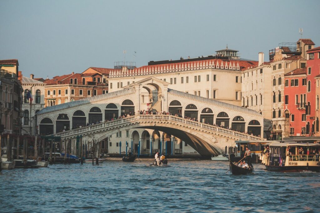 a bridge over a body of water with buildings in the background